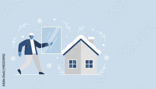 Professional worker installing a window on a snowy house Home maintenance and construction during winter