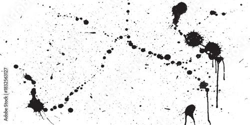 Abstract black ink splatters and drips on a white background.
