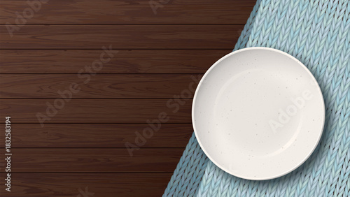 Top view of empty ivory bowl placed on a light blue placemat on a wooden table