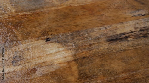 Wet Wooden Floor Surface: Water Stains and Moisture on Natural Wood Grain Texture Background with Scratches