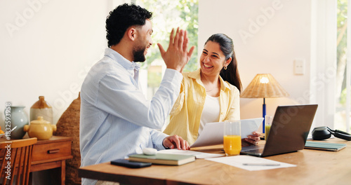 Documents, high five and couple in home with laptop for paying off bills, debt or mortgage. Happy, financial paperwork and man with woman for celebration on computer for internet banking for purchase