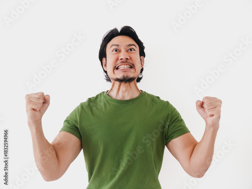 Excited energetic Asian man in green t-shirt with active pose isolated on white.