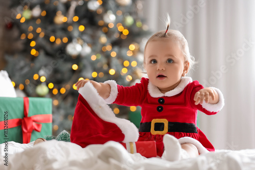 Cute little baby in Santa c...