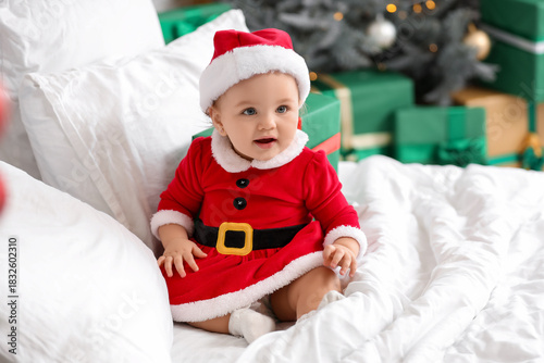 Cute little baby in Santa c...