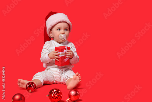 Cute little baby in Santa h...