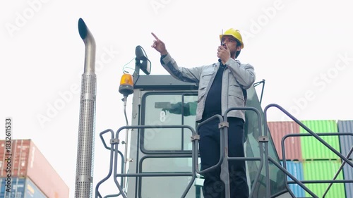 Logistic or engineer man talking on walkie-talkie explain project with colleague on forklift in container warehouse. inspecting for quality control. shipping delivery and export import