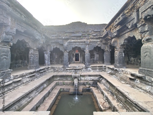 Ancient Krishnai Temple in Mahabaleshwar showcasing the sacred origin of the Krishna River, with stone pillars, carved architecture, stepped platforms and the historic gomukh spring flowing.