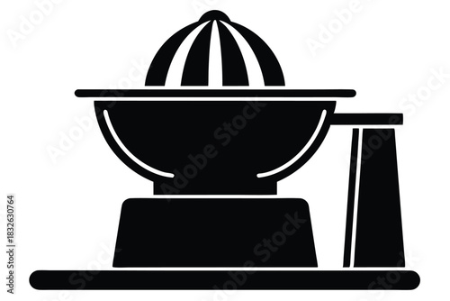 Black manual juicer sits on a table with a simple base structure