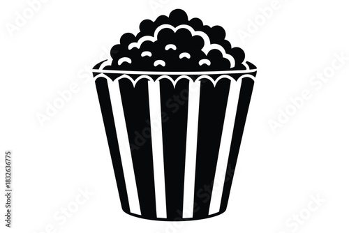 A stark black bucket overflows with classic popcorn against a plain white backdrop