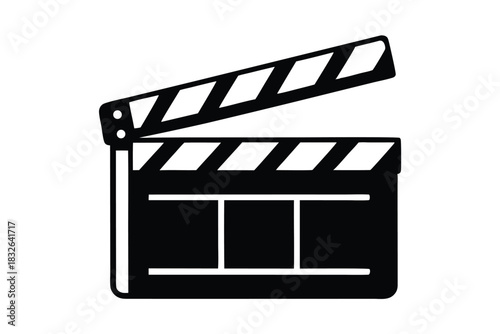 Black film clapperboard with white stripes stands open on the set ready for action