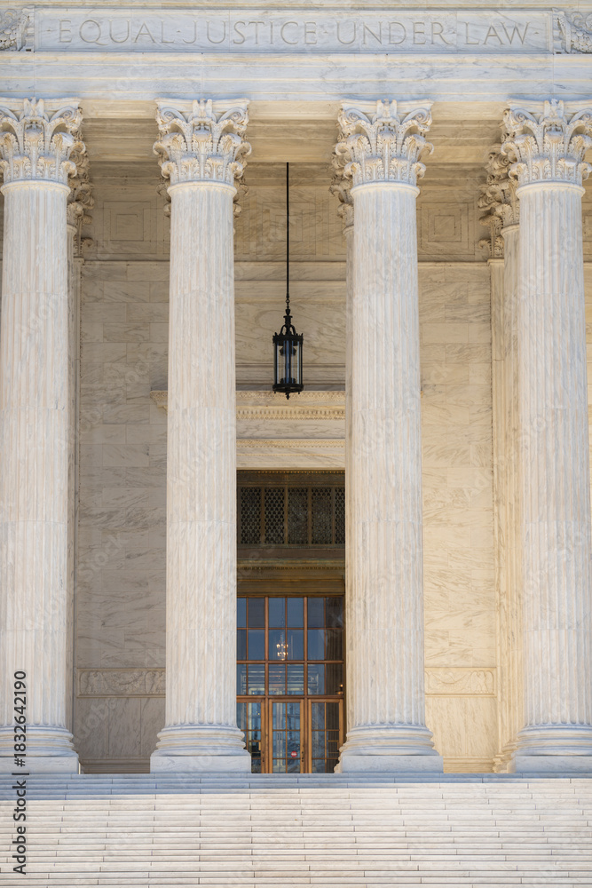 Fototapeta premium Historic government architecture with marble pillars. White stone columns shaping civic architecture. Court house exterior with classical design. Monumental columns emphasizing historic architecture.