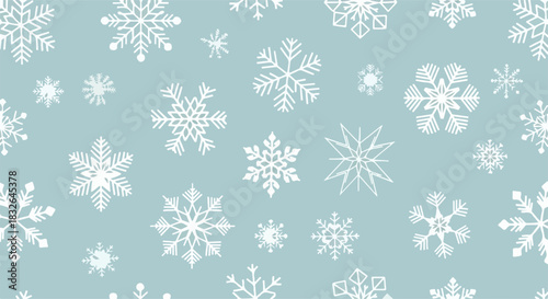 A festive and delicate seamless pattern of various white snowflakes scattered across a calm blue background, ideal for Christmas and winter holiday designs