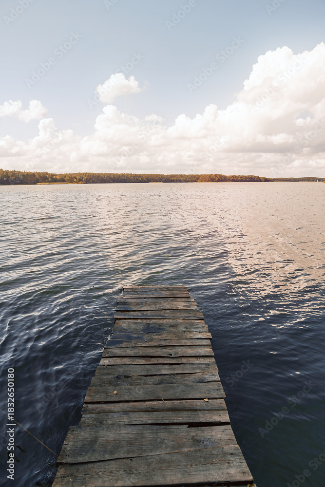 Fototapeta premium Tranquil lake with trees and blue sky