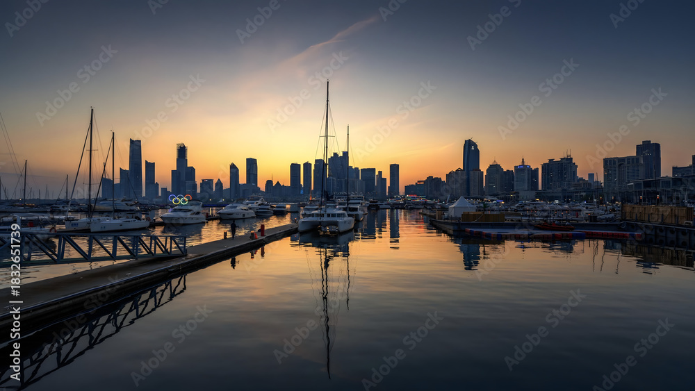 Fototapeta premium Sailboats and City Skyline at Sunset in Marina Harbor