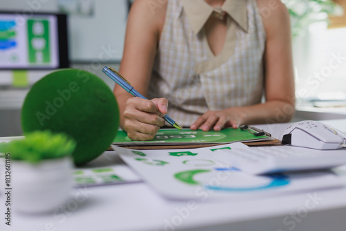 Person writing esg report for sustainable business strategy