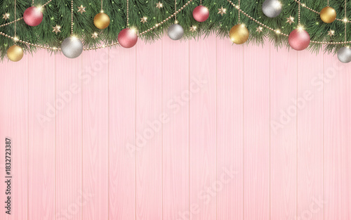 光輝くクリスマスツリーと、横長のピンクの木目の背景