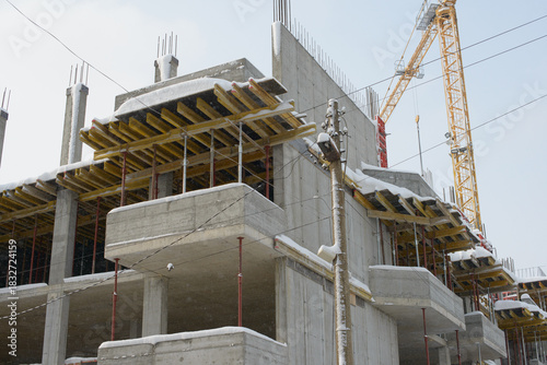 Concrete Structure Rising Through Light Falling Winter Snow