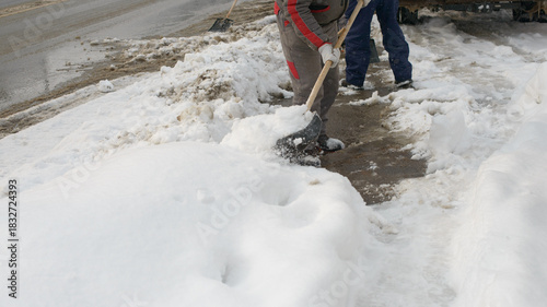 Clearing Snow From Sidewalk During Cold Winter Weather