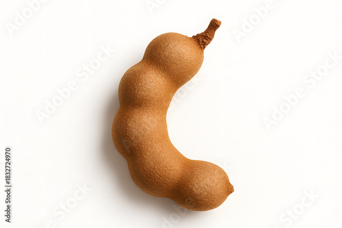 Single tamarind pod isolated on clean white background sweet sour brown fruit ingredient concept