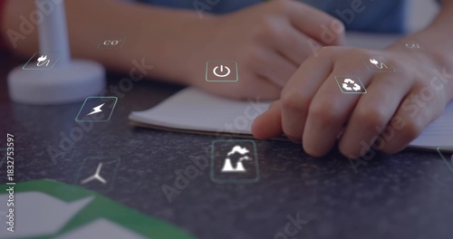 Writing children's hands tracing notes at study desk, open notebook and holographic energy icons