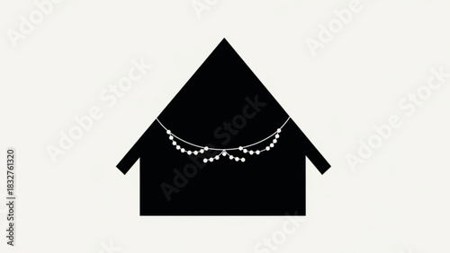 Simple black house silhouette adorned with a delicate white string of pearls creating a festive and elegant decorative garland across its facade