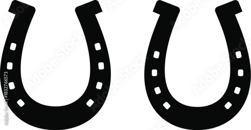 Two black horseshoes isolated on white background for good luck
