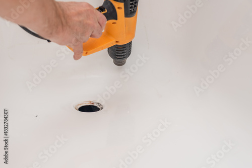 Fotografía Closeup photo of man with electric heat gun drying bath surface