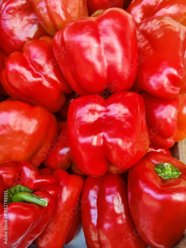 Sweet red bell peppers in store counter. Ripe peppers paprika, natural background. Healthy proper nutrition, diet. Fresh vegetable food. Close-up