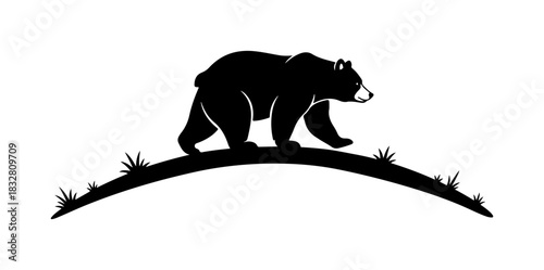 Majestic bear silhouette prowling across a grassy hilltop emblem