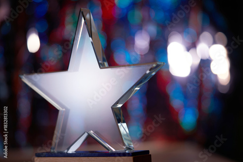 crystal star shape trophy against bokeh light as background