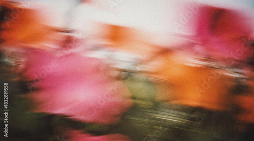 Abstract floral background with vibrant pink and orange hues creating a dreamy atmosphere, showcasing the beauty of nature in a blurred motion style