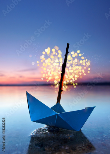 magical blue paper boat with lantern at the beach - romantic evening