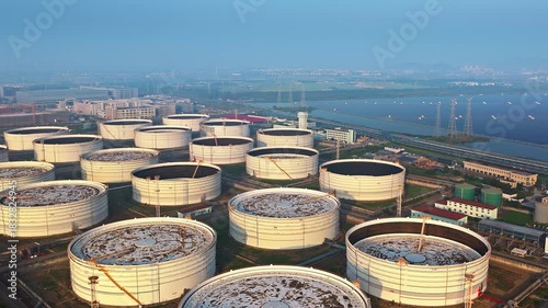 Aerial shot of large white oil storage tanks in petrochemical refinery plant in industrial area
