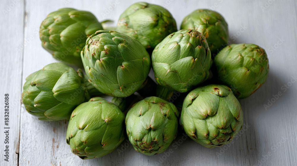 Fototapeta premium Close-up of fresh green artichokes on rustic wooden table.