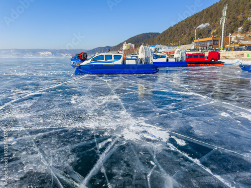  Hovercrafts on frozen icy surface of the Baikal lake . Clear winter weather