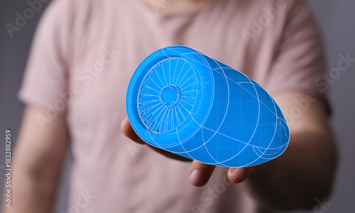 A person holds a 3D bluepri...