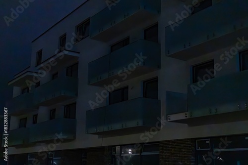 A multi-story building with dark windows at night. Power outages due to the war in Ukraine.
