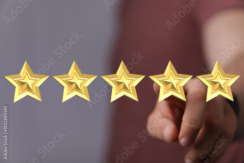 Hand pointing to five golde...