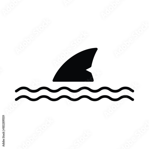 Shark fin silhouette emerging from wavy water