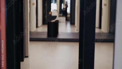 Wallpaper Mural Courier wearing a black sweater carrying a parcel for shipment inside a modern building entrance Torontodigital.ca