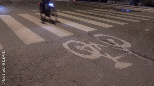 Stockholm, Sweden Bicycles on a rainy bike path at night.