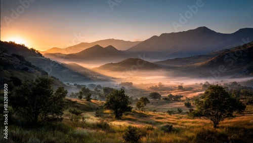 Golden Dawn Illuminates Majestic Mountains and Foggy Valley Landscape