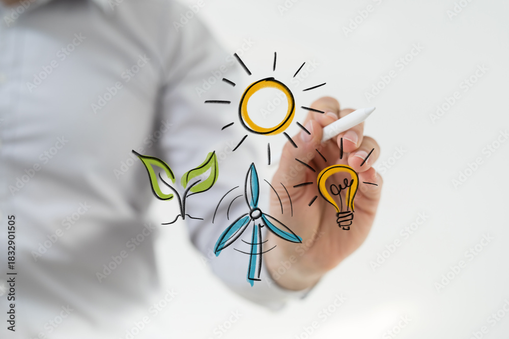 Fototapeta premium Human hand drawing digital illustrations of renewable energy concepts: solar, wind, green plant, and light bulb, symbolizing sustainability and