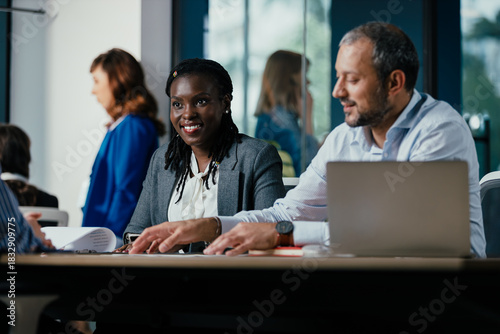 Smiling Black Woman Leading Feedback Session Meeting in Modern Open Office