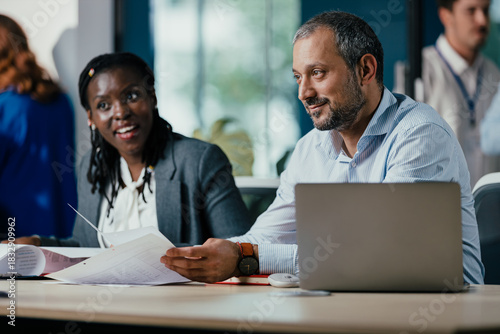 Smiling Black Woman Leading Feedback Session Meeting in Modern Open Office