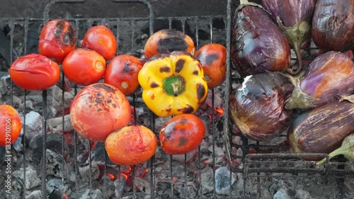 Grilling vegetables barbecue, tomatoes peppers eggplants cooking on hot coals