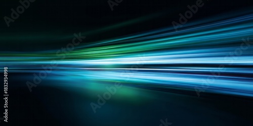 Intense motion blur streaks across a dark background with vibrant blue and green light trails