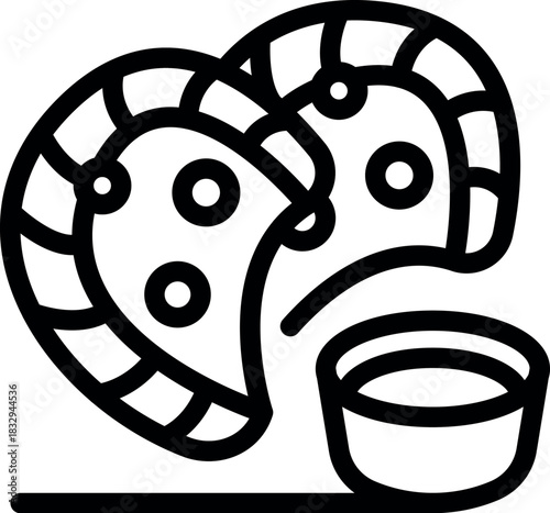 Two half moon shaped gujiya cookies with dipping sauce, a sweet treat enjoyed during the holi festival