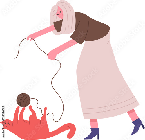 Woman playing with cat and yarn ball