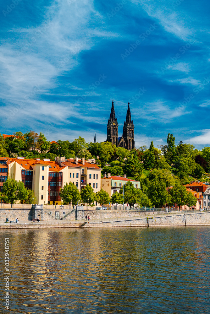 Obraz premium Vysehrad Basilica and colorful buildings along Vltava embankment.